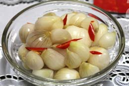 A bowl of Dua Hanh a type of Vietnamese pickled onions cured with salt, ginger and chillis